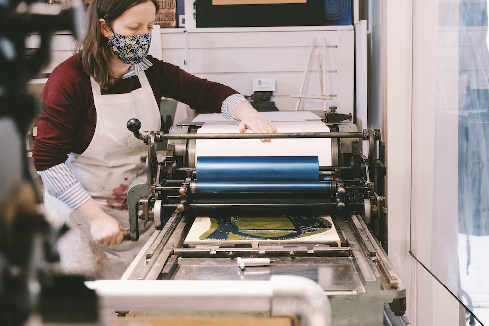 A letterpress printer uses the Vandercook printing press