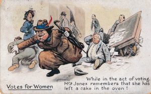 In this postcard, the suffragette is again shown as a wild, unwomanly, and violent character. Masculine dress and umbrellas become common identifiers in the popular imagery of the suffragette. These were used to suggest that their manly dress was a poor attempt to imitate a man, and that their umbrella was a weapon to potentially be used in violence by them.