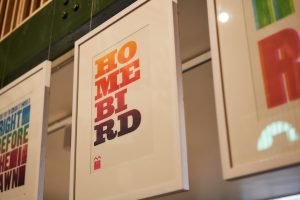 Locked Up in Lockdown installation shot, print reading 'Homebird'