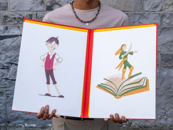 Someone holds open the portfolio containing the letterpress-printed illustrations of Blot and Grainne Mhaol.