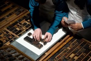 Students use wood type to compose words