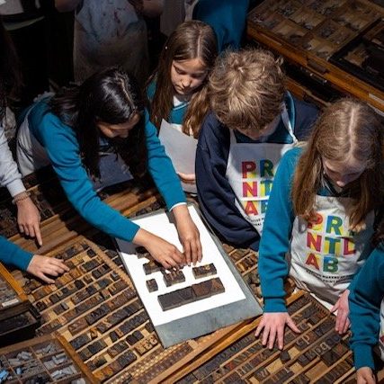 Students use wood type to compose words