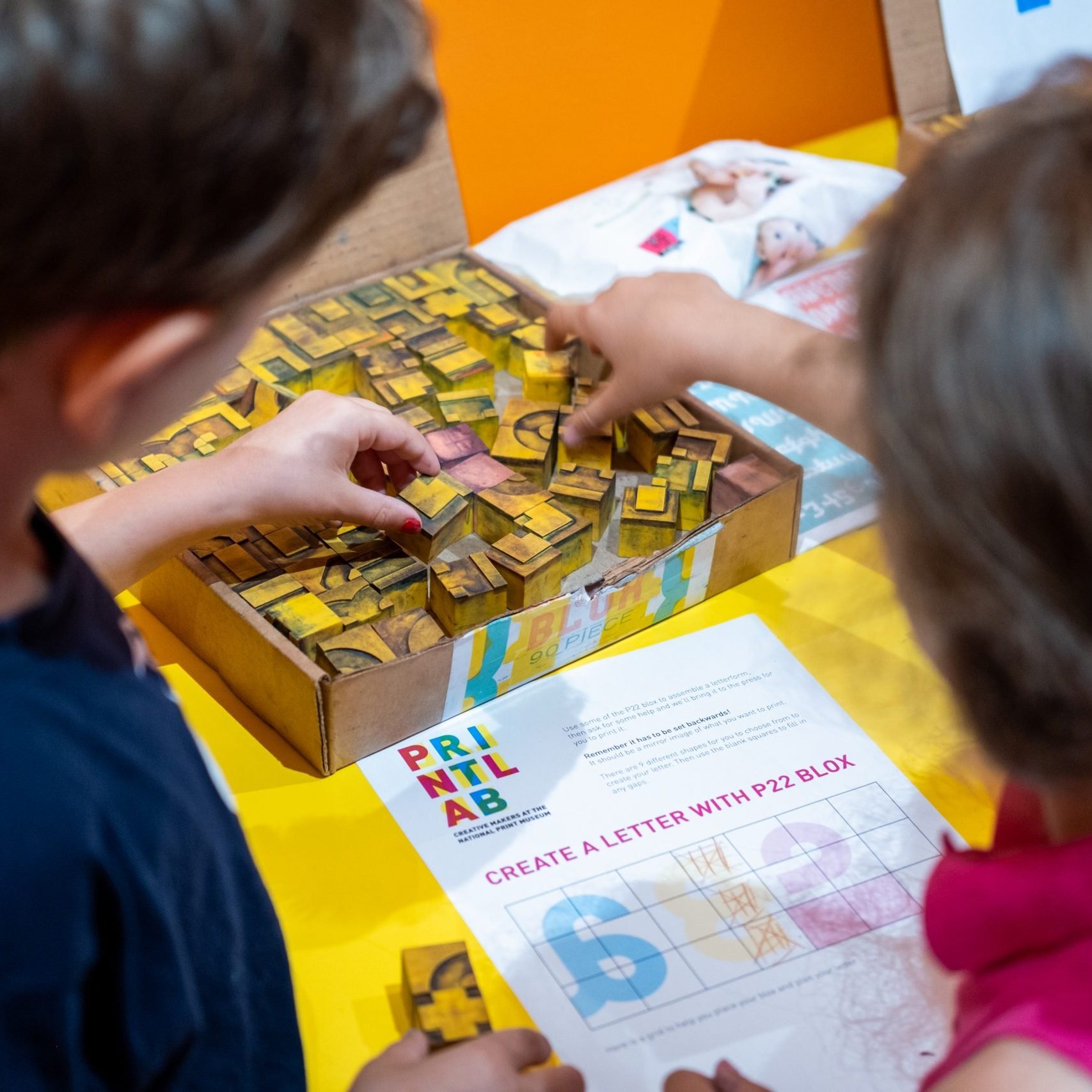 2 children assemble P22 Blox to create a print.