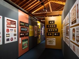 A view of the temporary exhibition 'Grand Stuff: Label Art in Ireland' in which the framed labels and information panels can be seen