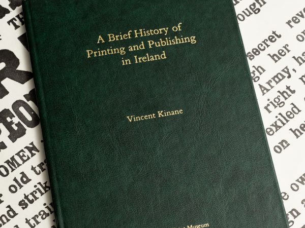 a photo of the book 'A Brief History of Printing and Publishing in Ireland' resting a replica of the Irish Proclamation
