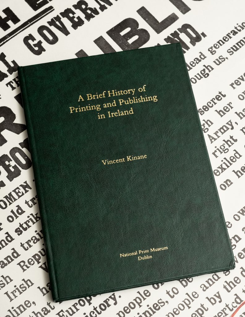 a photo of the book 'A Brief History of Printing and Publishing in Ireland' resting a replica of the Irish Proclamation