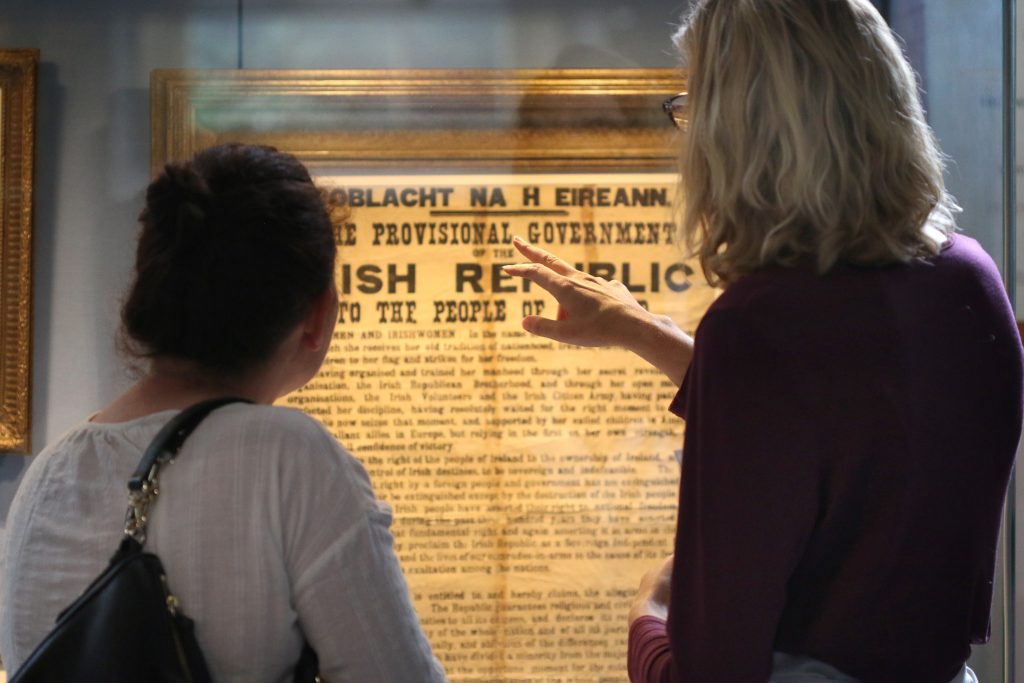 A tour guide points out details of an original copy of the Irish Proclamation on display in the Museum