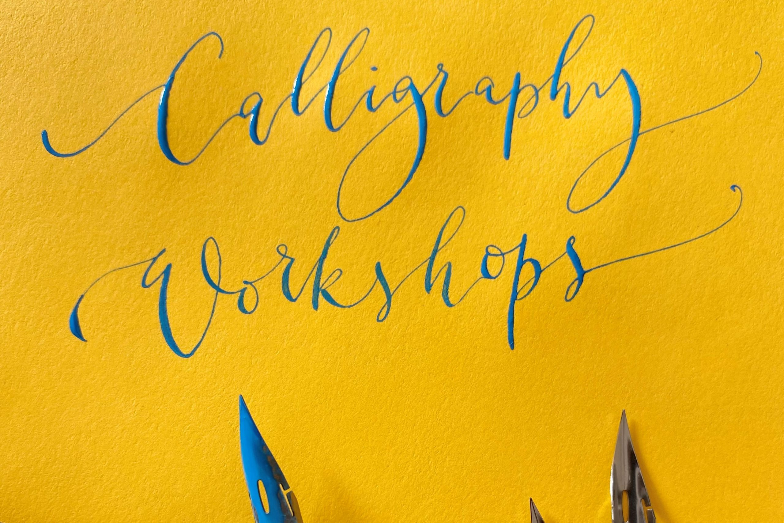 'Calligraphy workshop' written in stylised calligraphy with blue ink