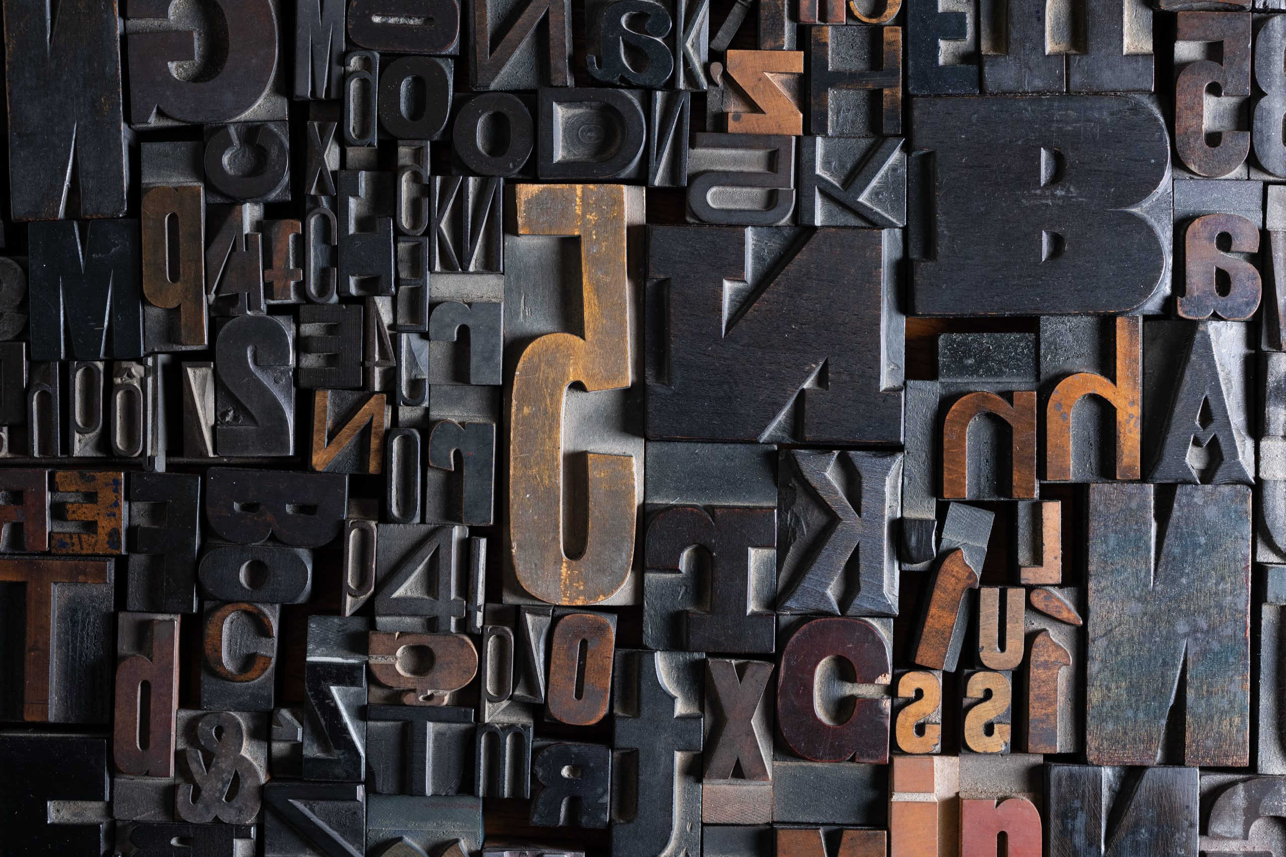 A collage of various letters and numbers in wooden type