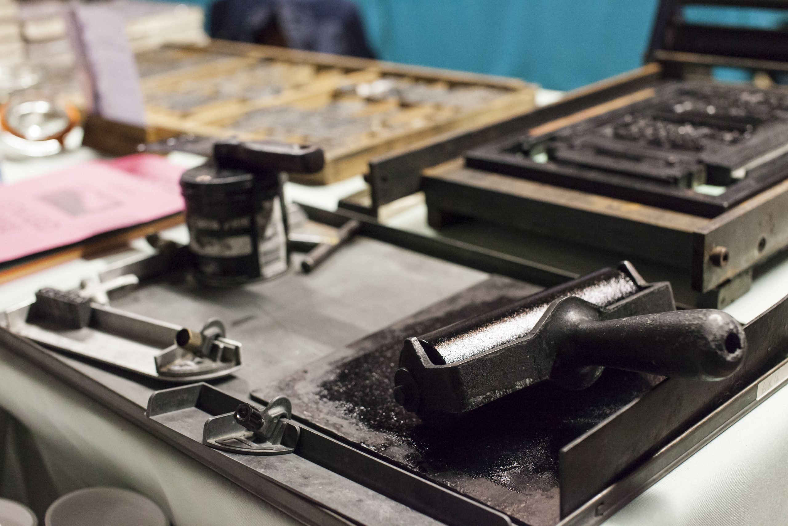 An ink roller sits next to a proofing press