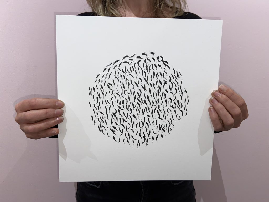 Print of small black fish in a shoal